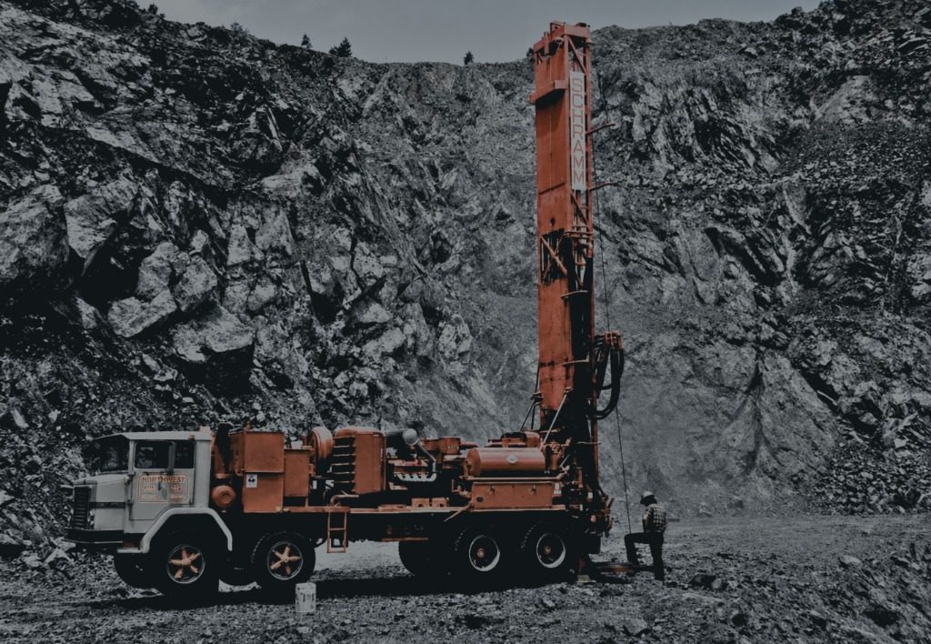 Red WesternAir drilling rig in a rocky pit